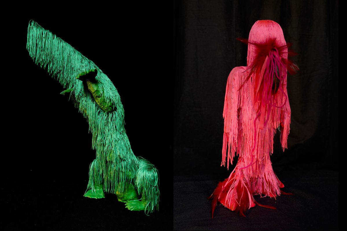 two sculptures of fringed creatures